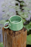 ring mug with elvish text and logo on a wooden beam